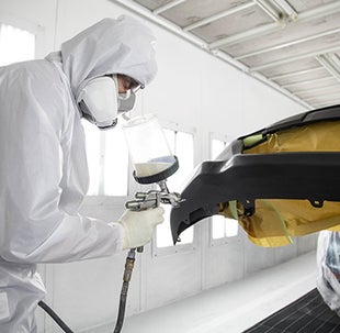 Collision Center Technician Painting a Vehicle | Newbold Toyota in O Fallon IL