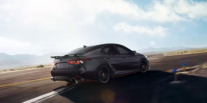 Rear black view of Camry driving on a highway