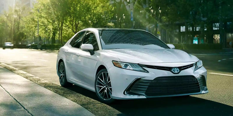 front view of white Camry parked