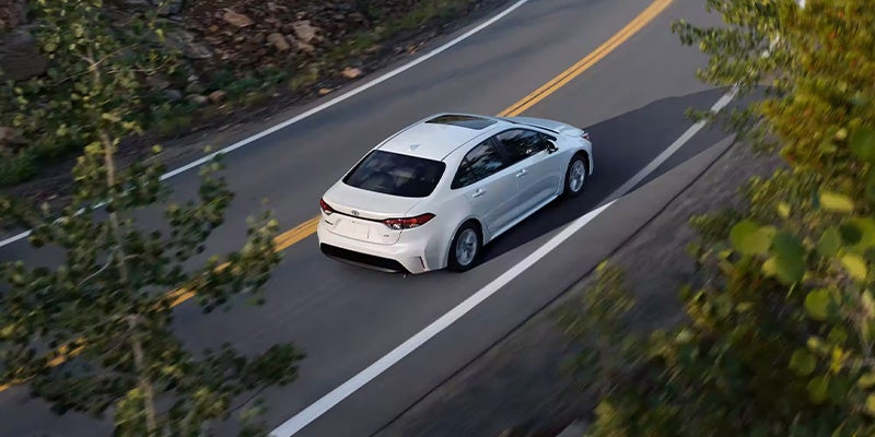 White Corolla driving on highway