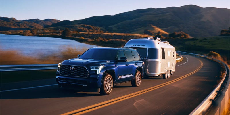 Exterior view of blue Sequoia driving on highway