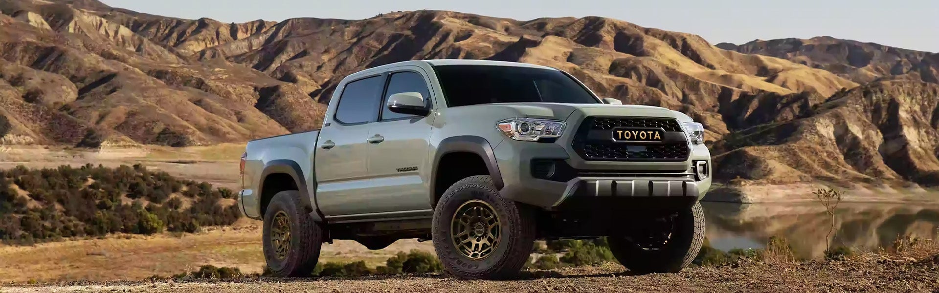 Exterior view of white Tacoma parked in the desert
