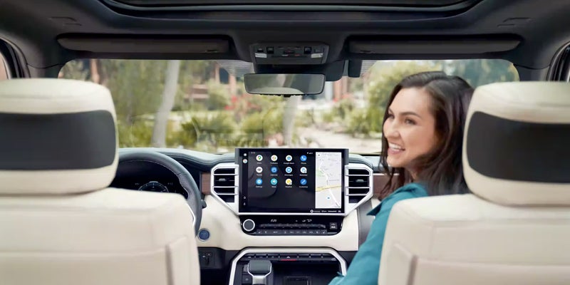 Interior view of console with woman sitting in passenger seat