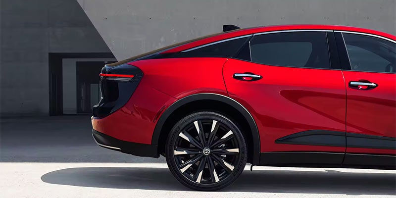 Side rear view of a red 2024 Toyota Crown