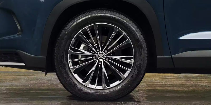 Closeup of the wheels on a blue 2024 Toyota Grand Highlander