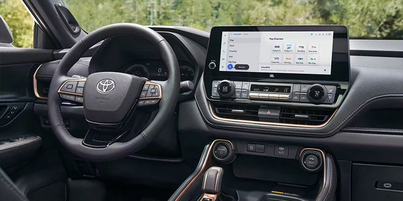 Interior closeup of the steering column and touchscreen on a 2024 Toyota Grand Highlander