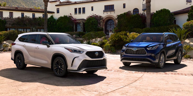 Two 2024 Toyota Highlander's are parked in a driveway