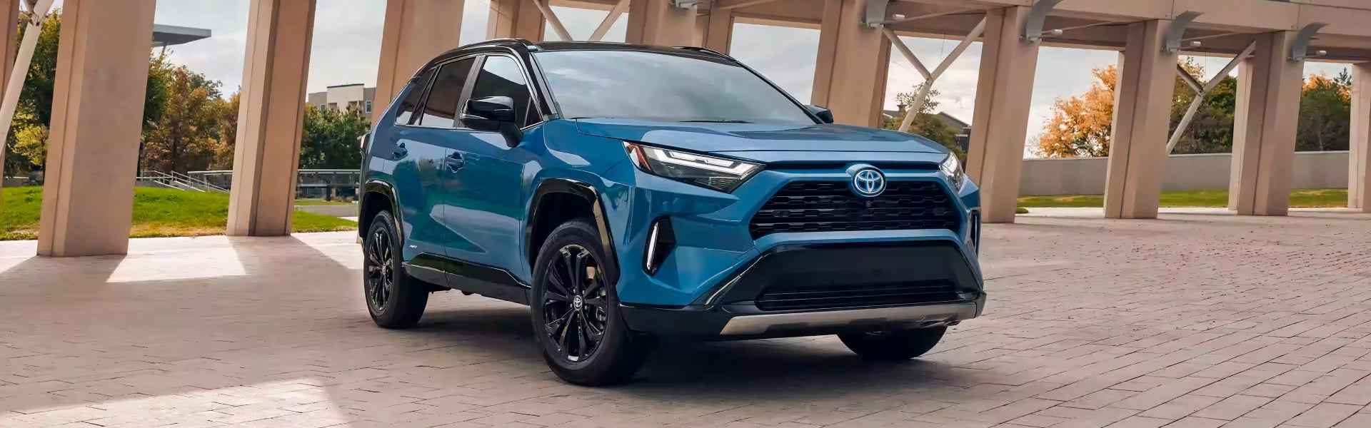 Front left view of a blue 2024 Toyota RAV4 Hybrid