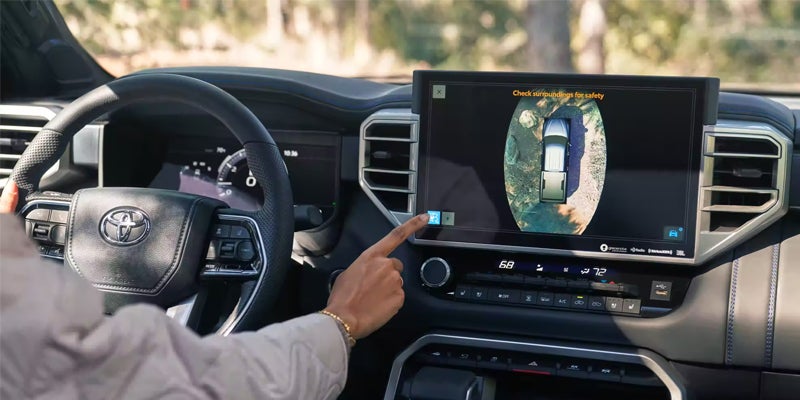 Interior view of driver operating touch screen